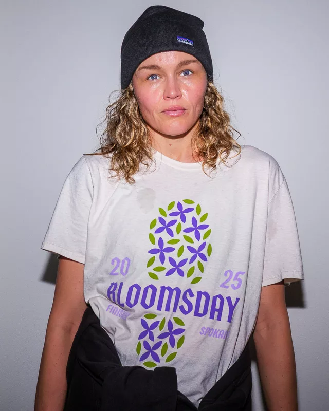 Woman wearing 2025 Bloomsday race t-shirt and black beanie, facing camera